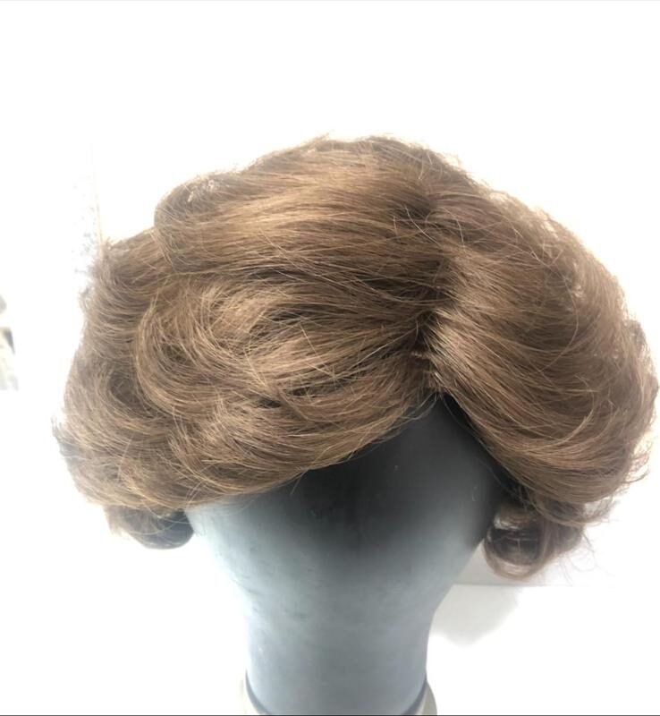 Peluca de cabello castaño peinada y con cuerpo después de la reparación